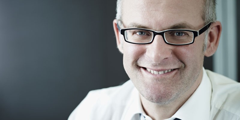 Confident businessman smiling at camera